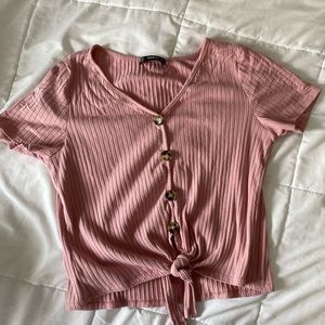 A dark pink button up tied top.